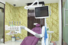 Dental treatment room featuring a yellow chair, LED light, and advanced dental instruments