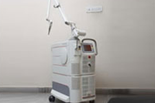 Contemporary dental unit with an orange-yellow chair and ceiling-mounted dental ligh