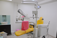 Modern dental chair setup with overhead monitor and attached instruments