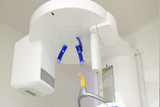 Modern dental operatory with a yellow dental chair and mounted treatment equipment